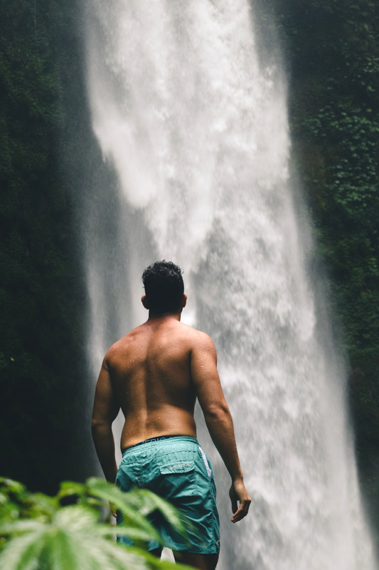 Canva - Man Looking at Waterfalls